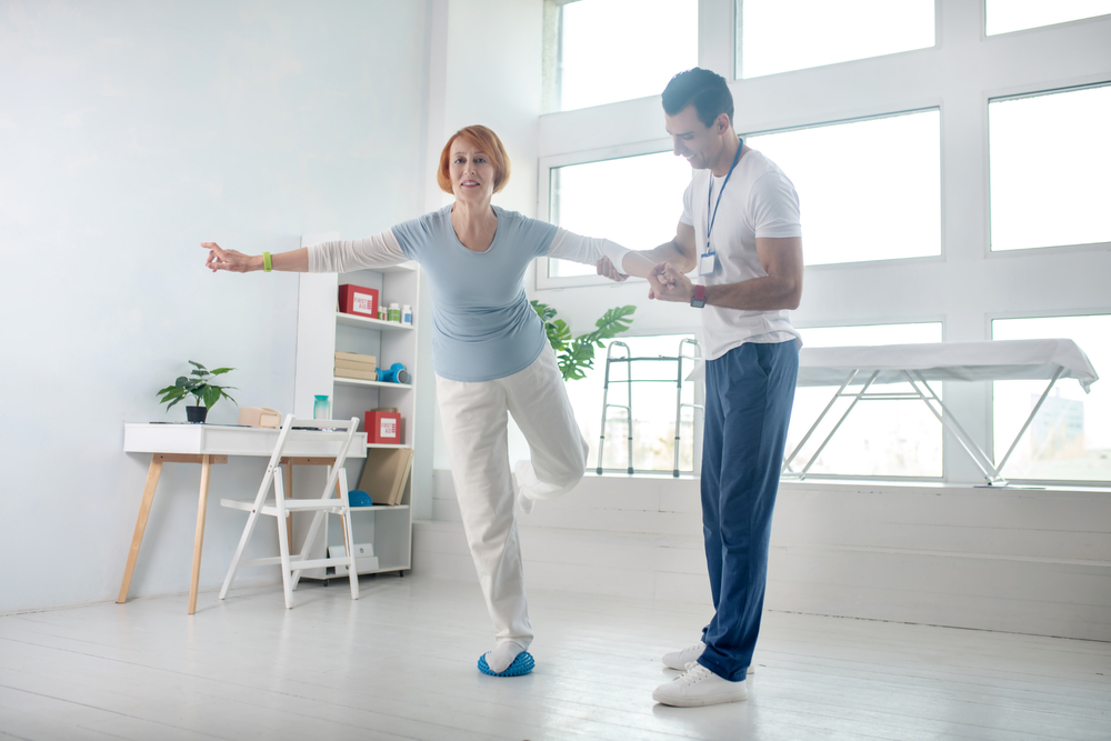man holding womans arm while she is balancing