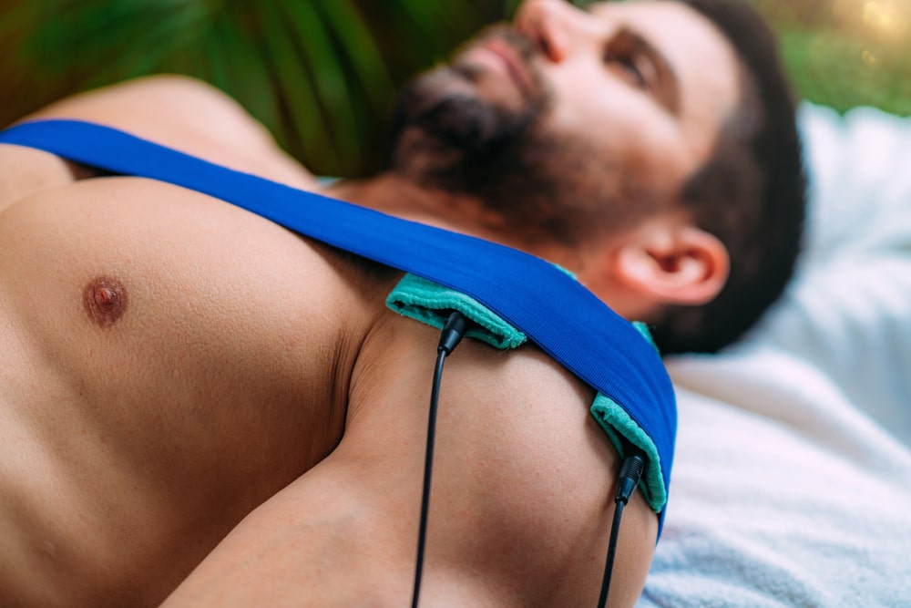 using device on shoulder to help with pain and take readings