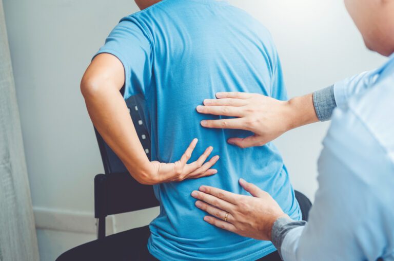 person getting back pain treated by a physical therapist